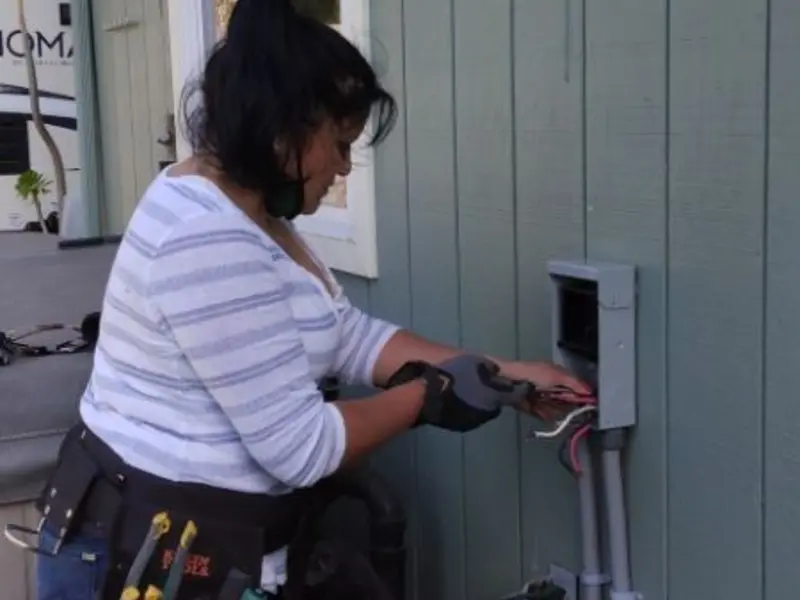 Licensed electrician wiring an exterior subpanel in McDonald