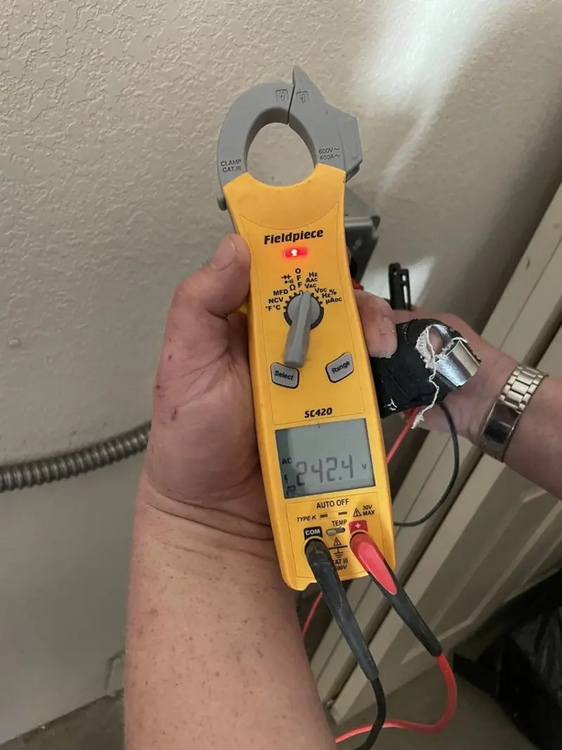 Voltage testing with clamp meter during Whole House Surge Protector in McDonald